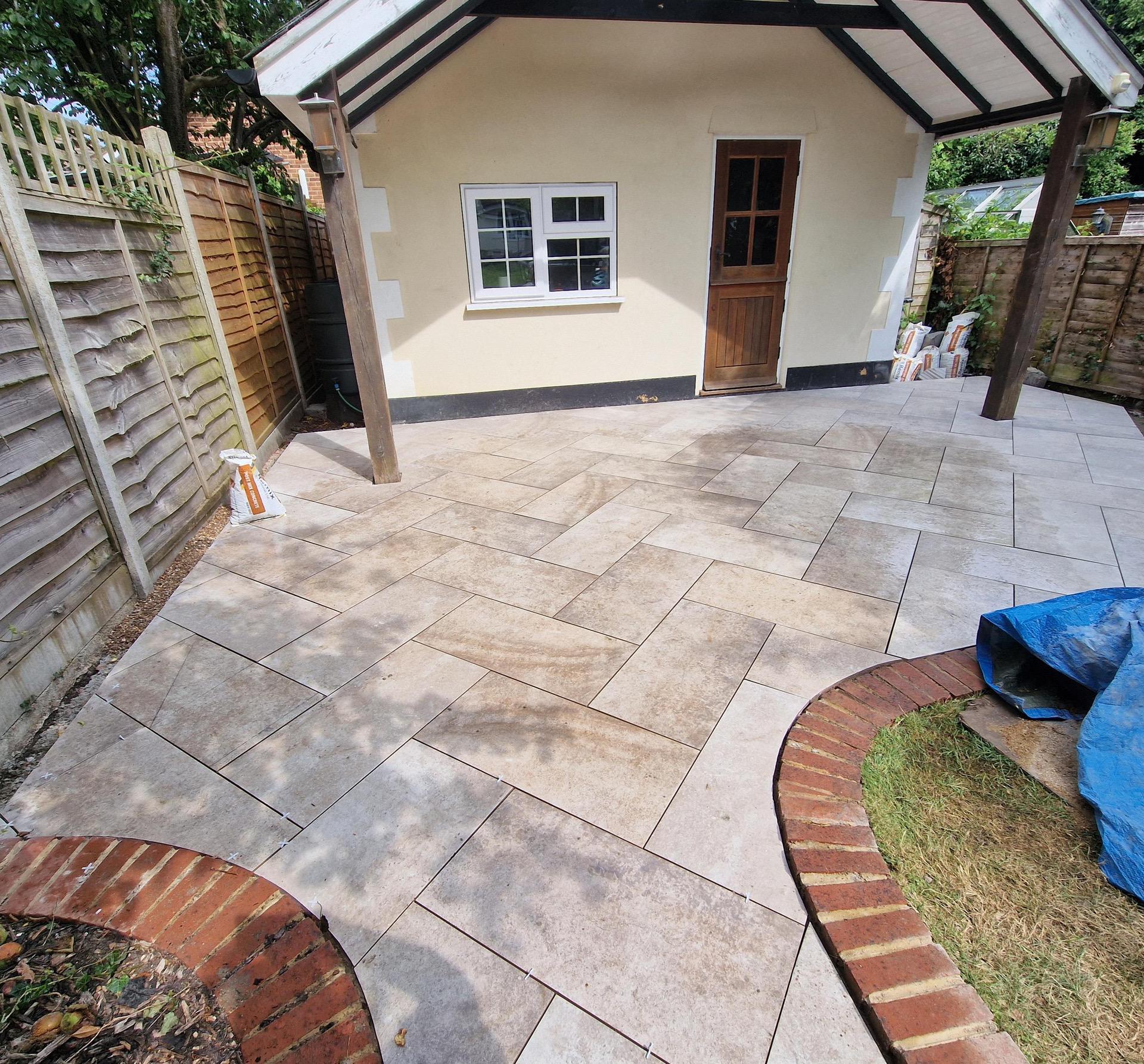 Completed herringbone layout on patio area in front of garden summerhouse.